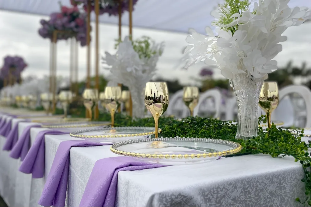Purple table settings with white centrepieces and gold goblets